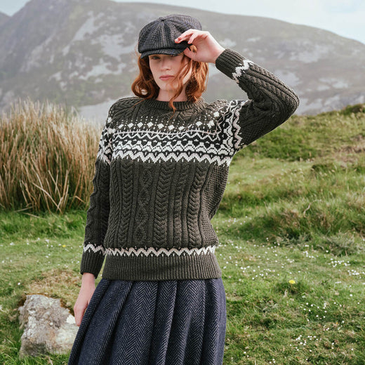 Image featuring the Women's Fairisle Cable Knit Sweater in army green, crafted with traditional Fair Isle patterning and authentic Irish cable knit textures, blending heritage-inspired design with timeless knitwear style.