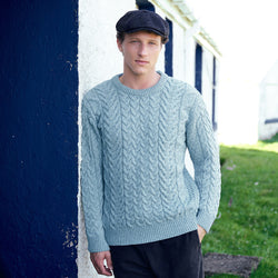 Image featuring the Men's Cable Knit Crew Neck Sweater in mermaid, crafted with authentic Irish cable knit patterns and a timeless crew neck silhouette, showcasing traditional Aran craftsmanship inspired by Ireland's coastal heritage.