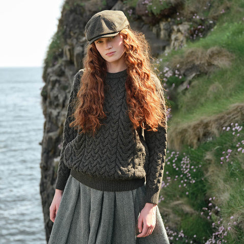 Image featuring the Women's Cable Knit Crew Neck Sweater in army green, crafted with authentic Irish cable knit patterns and a timeless crew neck silhouette, inspired by Ireland's rich knitting heritage and traditional craftsmanship.