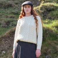 Image featuring the Women's Cable Knit Crew Neck Sweater in natural cream, crafted with authentic Irish cable knit patterns and a timeless crew neck silhouette, inspired by Ireland's rich knitting heritage.